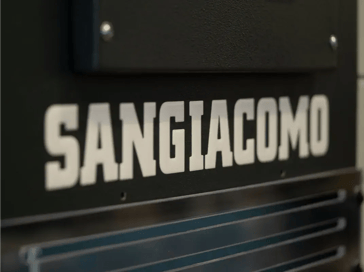 Blue Sangiacomo flywheel press machine with safety guards in workshop