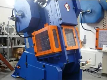 Blue Sangiacomo flywheel press machine with safety guards in workshop