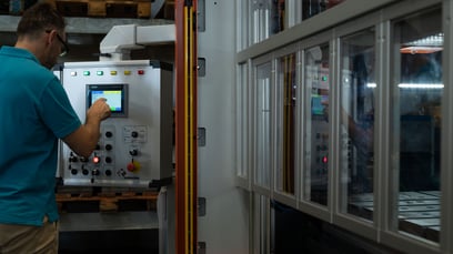A worker operating a single-point press by Sangiacomo Presses Americas.